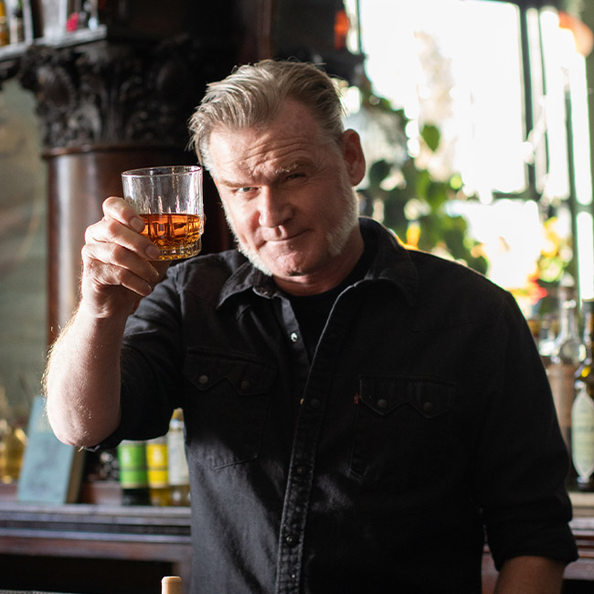 Master Distiller & Blender Rob Dietrich toasting with a glass of BLACKENED American Whiskey