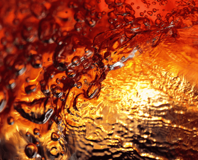 Close up of BLACKENED Whiskey being poured from the bottom of a glass