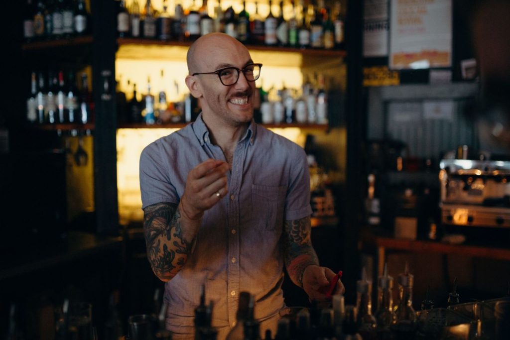 Mixologist Donny Clutterbuck smiling pointing at the camera