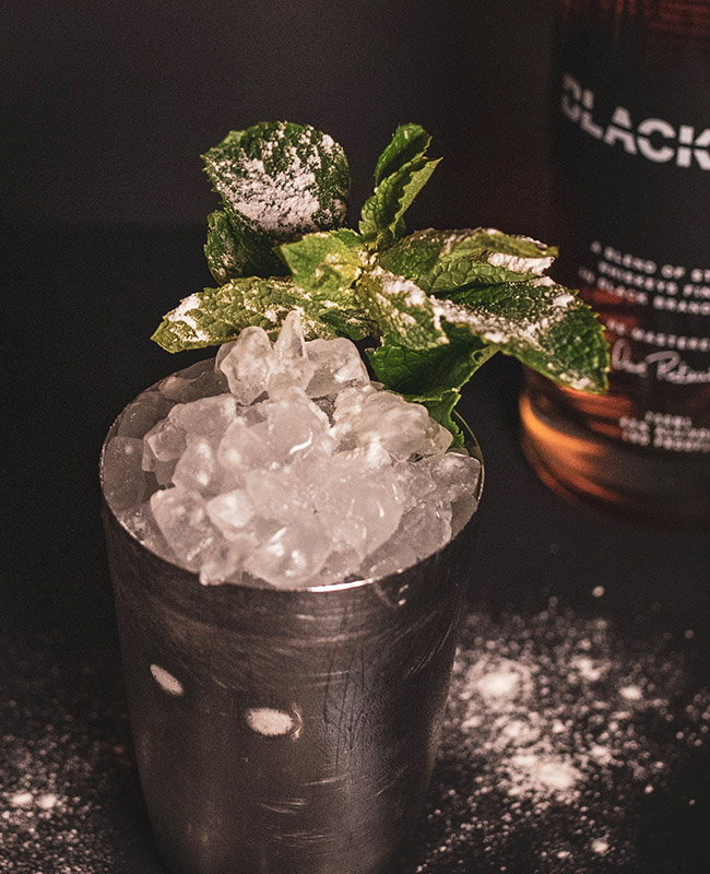 Cocktail Shaker with ice and a mint leaf for a Mint Julep Cocktail
